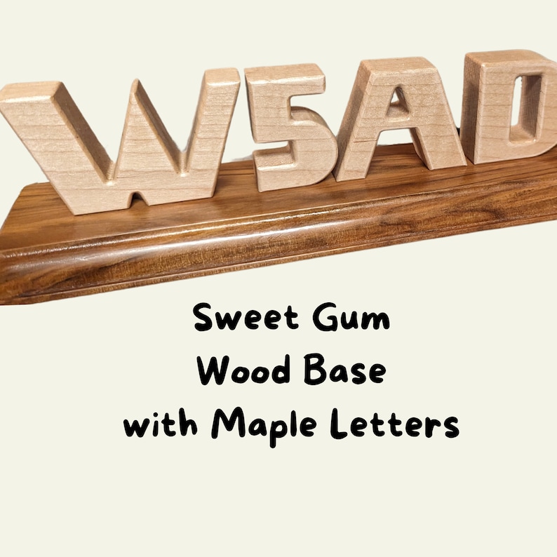 Blonde Maple wooden carved block-style letters "W5AD", they are a ham radio call sign. The base has a dark rich grain giving it a polished, professional look. The wood is sweet gum and is finished with Danish Oil.