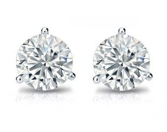 May include: A pair of silver stud earrings with a large, clear, round, faceted gemstone in the center of each earring.