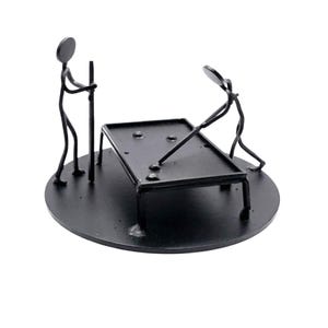 May include: A white ceramic mug with a black handle and the text "But First, Coffee" in a bold, black font. The mug is set against a neutral background, highlighting its simple design.