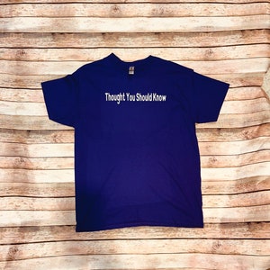 May include: A navy blue t-shirt with the text "Thought You Should Know" printed in white on the front.