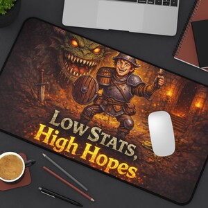 May include: A rectangular mousepad featuring a fantasy illustration of a smiling knight with a shield and sword, facing a green dragon. The text "Low Stats, High Hopes" is displayed in gold. A computer mouse rests on the pad.