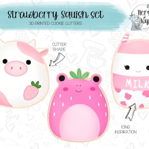 May include: A set of three 3D printed cookie cutters shaped like a cow, a frog, and a milk carton. Each cutter has a strawberry on it. The cutters are pink, white, and green. The text "Strawberry Squish Set" and "3D Printed Cookie Cutters" is at the top of the image. The text "Cutter Shape" is next to the cow cutter. The text "Icing Inspiration" is next to the milk carton cutter.