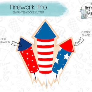 May include: A 3D printed cookie cutter shaped like three fireworks. The fireworks are red, white, and blue with a star pattern. The cookie cutter is designed for making cookies for the 4th of July or other patriotic holidays.