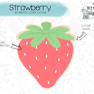 May include: A 3D printed cookie cutter in the shape of a red strawberry with green leaves. The cutter is designed for making cookies and is labeled "Strawberry 3D Printed Cookie Cutter".