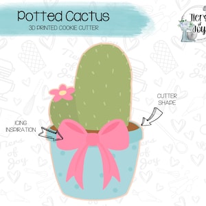 May include: A 3D printed cookie cutter shaped like a potted cactus with a pink bow. The cutter is designed to create cookies in the shape of a cactus plant in a pot.