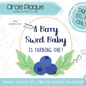 May include: A digital download STL file for a cookie cutter in the shape of a circle with the text "A Berry Sweet Baby Is Turning One!" and blueberries with leaves around the text.