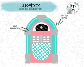 May include: A 3D printed cookie cutter shaped like a vintage turquoise and pink jukebox. The cutter has a record on the front and a grid pattern on the bottom. The text "Jukebox" and "3D Printed Cookie Cutter" is above the cutter.