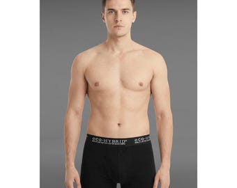 May include: Black boxer briefs with a white waistband featuring the text "eco-HYBRID". The briefs are made of a soft, cotton blend fabric. The model is standing in front of a gray background.