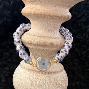 Blue Floral Beaded Bracelet with Blue Flower Resin Charm.