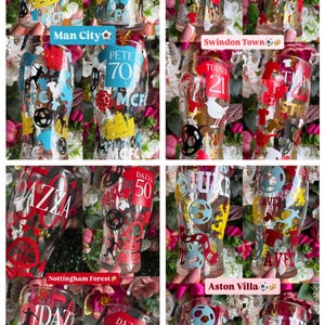 May include: A collection of clear pint glasses with colorful football-themed designs. Each glass features team logos, player silhouettes, and text, including "Man City", "Swindon Town", "Nottingham Forest", and "Aston Villa".