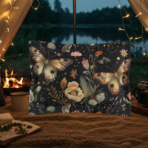May include: A rectangular pillowcase featuring a black background with a repeating pattern of large brown and cream butterflies, various light-colored flowers, green leaves, and small golden stars scattered throughout the botanical design.