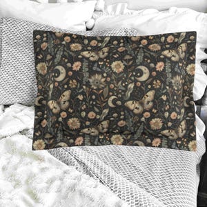 May include: A black pillowcase with a floral pattern featuring butterflies, moons, and stars. The pattern is in shades of brown, cream, and white.