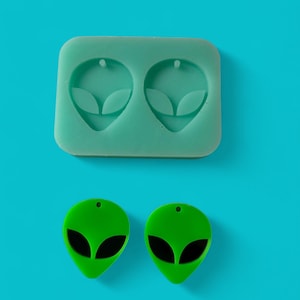 May include: Two green alien head shaped silicone molds and two green alien head shaped earrings.