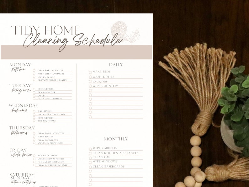 K&ouml;nnte beinhalten: Eine druckbare Checkliste f&uuml;r einen Reinigungsplan mit einem floralen Design. Die Checkliste enth&auml;lt t&auml;gliche, w&ouml;chentliche und monatliche Reinigungsaufgaben f&uuml;r K&uuml;che, Wohnzimmer, Badezimmer und das gesamte Haus. Der Text enth&auml;lt "Tidy Home Cleaning Schedule".
