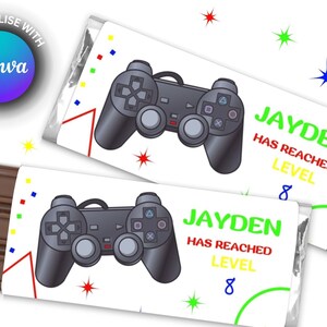 May include: Two white chocolate bar wrappers featuring a black and grey video game controller design. The wrappers display the text "JAYDEN HAS REACHED LEVEL 8".