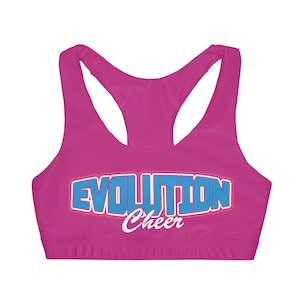 May include: Pink sports bra with a blue and pink "Evolution Cheer" graphic.