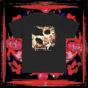 May include: A black short-sleeve t-shirt featuring a central graphic print of an anime-style character with light hair. The design includes text that reads "Foreground Eclipse" and "Stories Will Become Melodies Tonight" in a distressed white font.