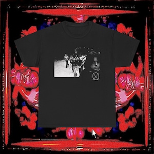 May include: Black t-shirt with a black and white image of people walking. The shirt also features a graphic of a circle with an X inside. The background has a red and black design.