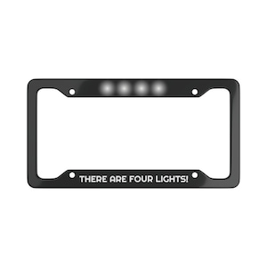 Può includere: Cornice per targa nera con quattro luci LED bianche e il testo "THERE ARE FOUR LIGHTS!"