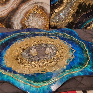 May include: A blue and green resin serving tray with gold accents and a crystal-like design. The tray has two clear acrylic handles.
