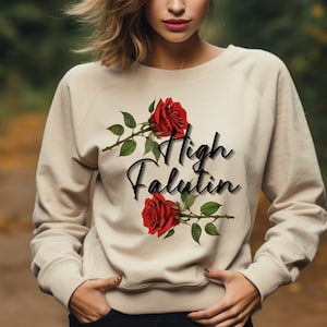 May include: A beige sweatshirt with a graphic of red roses and the text "High Falutin".