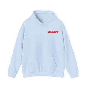 May include: A pale blue hoodie with a front pocket and a drawstring hood. The red text "SDN" is printed on the upper chest. The hoodie is made of a soft material.