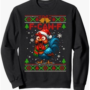 May include: Black sweatshirt with a colorful rooster graphic wearing a Santa hat and a scarf. The rooster has blue feathers and a red comb. The text "F-CAW-F" is above the rooster. The design includes snowflakes and Christmas tree patterns.