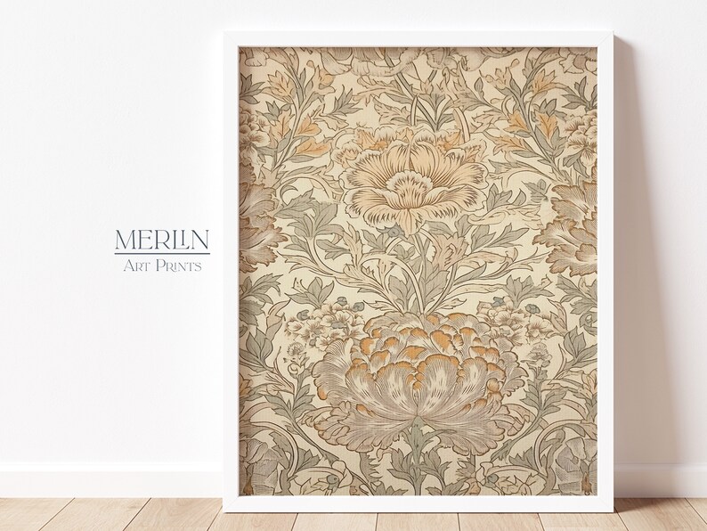 May include: A framed print of a vintage floral pattern with a cream background and brown and green flowers. The print is in a white frame.