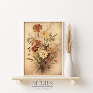 May include: A vintage-style print of a bouquet of flowers in shades of brown, yellow, and white. The flowers are arranged in a vase and are set against a light brown background. The print is titled "MERLIN ART PRINTS".