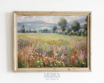 May include: A framed landscape painting depicts a vibrant wildflower meadow under a cloudy sky. The artwork features a variety of colorful flowers in the foreground, a grassy field, trees, and distant hills. The frame is a light gold color. The text "MERILN Art Prints" is at the bottom.