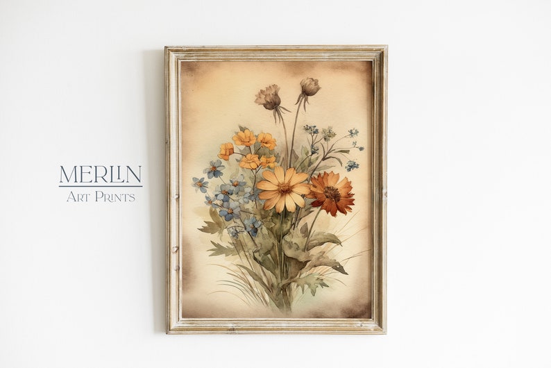 K&ouml;nnte beinhalten: Ein gerahmtes Aquarellbild eines Blumenstrau&szlig;es in Orange-, Gelb- und Blaut&ouml;nen. Die Blumen sind in einer Vase arrangiert und vor einem beigefarbenen Hintergrund platziert.