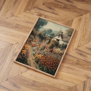 May include: A framed painting of a cottage with a garden in full bloom. The garden is filled with a variety of flowers in shades of red, yellow, and purple. The cottage is white with a brown roof and is surrounded by lush greenery.