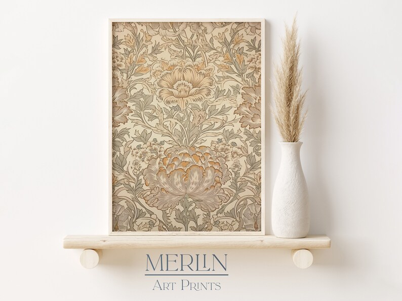 May include: A framed print of a vintage floral pattern in shades of beige, brown, and green. The print features a repeating pattern of stylized flowers and leaves. The frame is a simple, light wood color.