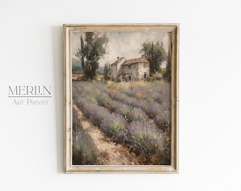 May include: A framed oil painting depicting a rustic farmhouse nestled in a field of lavender. The house is painted in muted tones of gray and white, with a red tile roof. The lavender field is a vibrant purple, with a dirt path leading through the center. The painting is set against a backdrop of rolling hills and a cloudy sky.