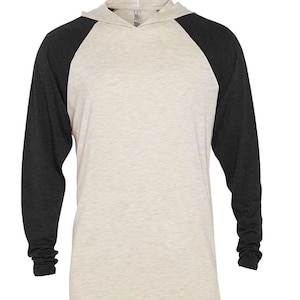 May include: A long-sleeved hooded shirt with a beige body and black sleeves. The sleeves are a baseball style with a contrasting color.