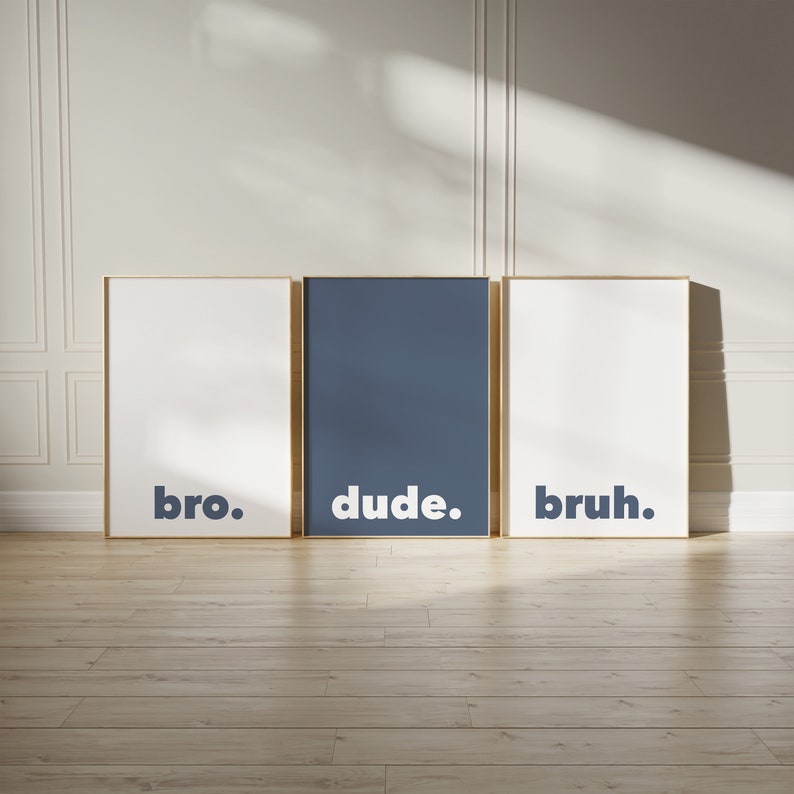 May include: Three framed prints with white backgrounds and gold frames. The prints have the words "bro.", "dude.", and "bruh." in bold, dark blue letters.