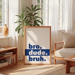 May include: A framed print with the words "bro. dude. bruh." in blue text on a white background.