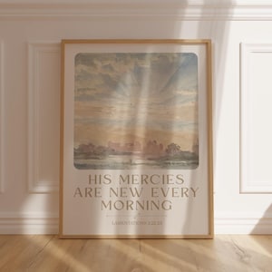 May include: A framed print with a watercolor painting of a landscape with a lake and trees. The text "HIS MERCIES ARE NEW EVERY MORNING" is printed below the painting, with the scripture reference "LAMENTATIONS 3:22-23" underneath.