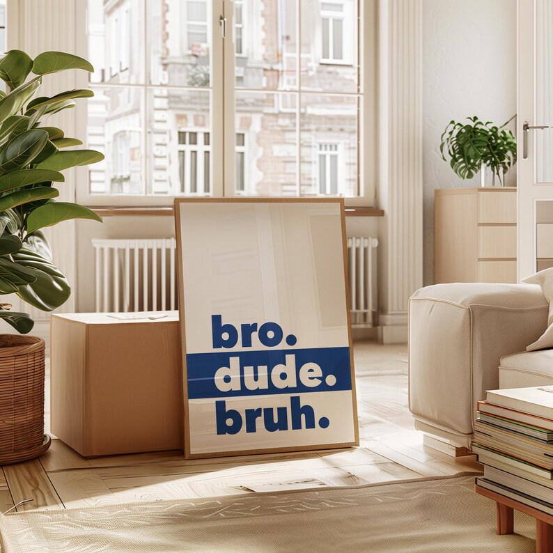 May include: A framed print with a white background and blue text that reads "bro. dude. bruh."