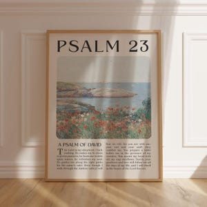 May include: A vertical wall art print featuring the text PSALM 23 at the top, a central landscape illustration of a rocky coastline with red flowers in the foreground, and the full text of the Psalm of David printed in black at the bottom.