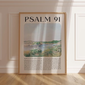 May include: Framed art print featuring the text "PSALM 91" at the top. The artwork depicts a serene landscape with a body of water, green foliage, and a light-colored sky. The bottom of the print contains text from the Psalm.