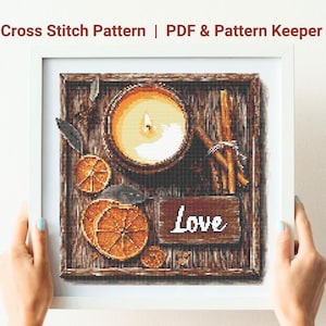 May include: Cross stitch pattern for a wooden tray with a lit candle, cinnamon sticks, orange slices, and the word "Love" written on a sign.