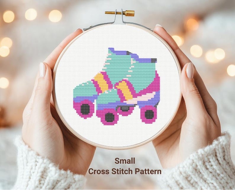 May include: A cross stitch pattern for a colorful roller skate. The skate is blue, pink, yellow, and white. The pattern is labeled "Small Cross Stitch Pattern".