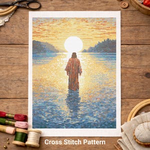 May include: A cross-stitch pattern depicting a figure in a robe standing in water, facing a bright sun. The scene is rendered in shades of blue, yellow, and orange. The text "Cross Stitch Pattern" is at the bottom.