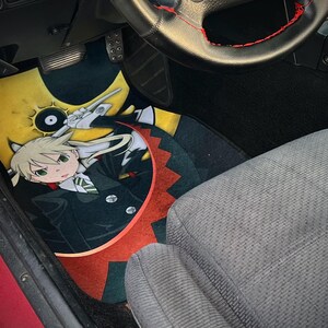 Custom Soul Eater car mats featuring Maka Albarn and her scythe partner, Soul. Inspired by the anime's action-packed adventures, these durable mats bring Death Weapon Meister Academy style to your ride. Perfect for fans of Maka, Soul