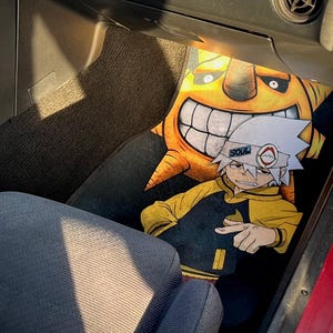 Custom Soul Eater car mats featuring Maka Albarn and her scythe partner, Soul. Inspired by the anime's action-packed adventures, these durable mats bring Death Weapon Meister Academy style to your ride. Perfect for fans of Maka, Soul