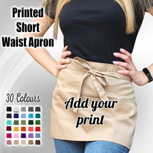 May include: A beige short waist apron with two pockets and a tie at the front. The apron has the text "Add your print" printed on it. There are 30 color swatches of the apron displayed below the image.
