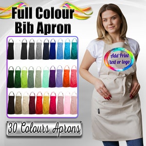 May include: A collection of 30 different colored bib aprons. The aprons are all made of a plain fabric and have a single pocket on the front. The text "Add Print (text or logo)" is visible on one of the aprons.