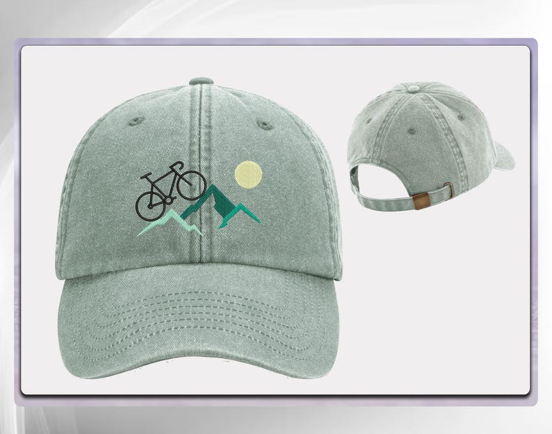 May include: A light green, adjustable, cotton baseball cap with an embroidered design of a bicycle riding up a mountain with a sun in the background.