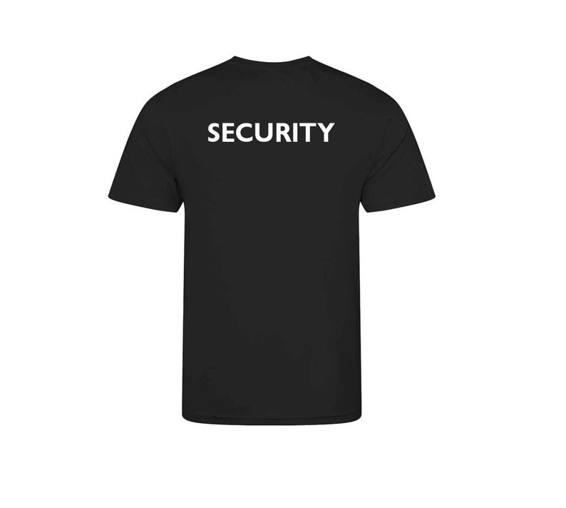 May include: Black t-shirt with the word "SECURITY" printed in white block letters across the back. The shirt has short sleeves and a crew neck. The fabric appears to be a soft, opaque material.